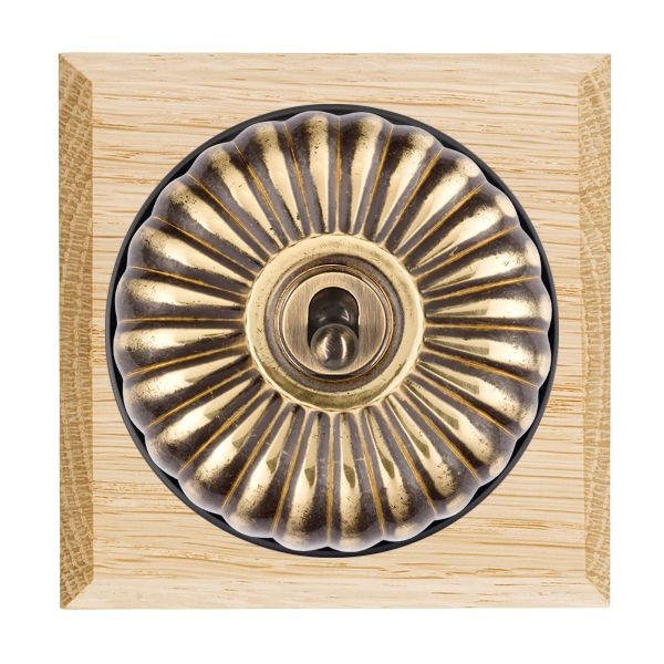 Hamilton Bloomsbury Chamfered Light Oak 1 Gang 20AX Intermediate Toggle Switch with Antique Brass Fluted Dome and Black Collar