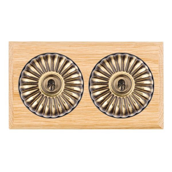 Hamilton Bloomsbury Chamfered Light Oak 2 Gang 20AX Intermediate Toggle Switch with Antique Brass Fluted Dome and Black Collar
