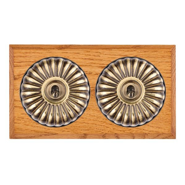 Hamilton Bloomsbury Chamfered Medium Oak 2 Gang 20AX Intermediate Toggle Switch with Antique Brass Fluted Dome and Black Collar