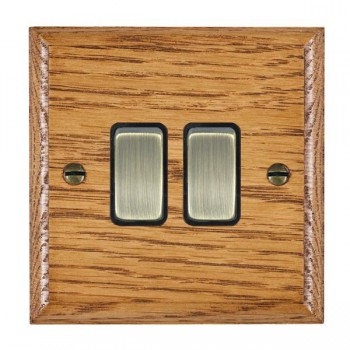 Hamilton Woods Ovolo Medium Oak 2 Gang 10AX 2 Way Switch with Antique Brass Rockers and Black Surround