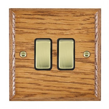 Hamilton Woods Ovolo Medium Oak 2 Gang 10AX 2 Way Switch with Polished Brass Rockers and Black Surround