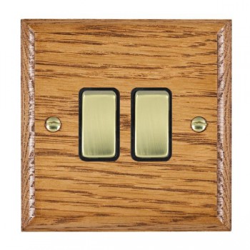 Hamilton Woods Ovolo Medium Oak 2 Gang 10AX 2 Way Switch with Polished Brass Rockers and Black Surround