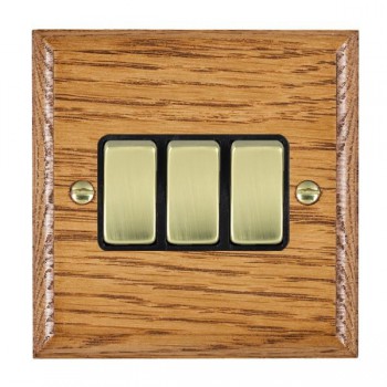 Hamilton Woods Ovolo Medium Oak 3 Gang 10AX 2 Way Switch with Polished Brass Rockers and Black Surround