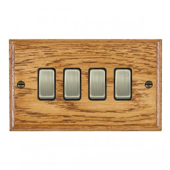 Hamilton Woods Ovolo Medium Oak 4 Gang 10AX 2 Way Switch with Antique Brass Rockers and Black Surround