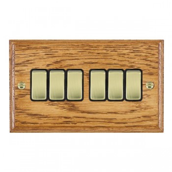 Hamilton Woods Ovolo Medium Oak 6 Gang 10AX 2 Way Switch with Polished Brass Rockers and Black Surround